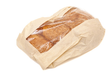 White bread with sesame in a paper bag isolated on white backgro
