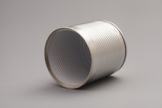 A silver tin can isolated on a gray background