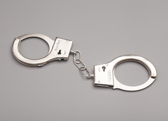 Handcuffs isolated on gray background