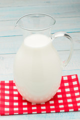 jug of milk on a red checkered tablecloth