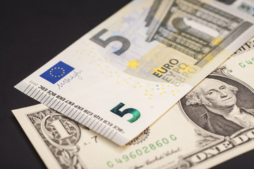 dollar and euro money isolated on black