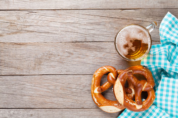 Beer mug and pretzel on wooden table