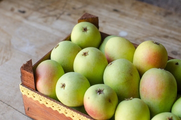 Wooden box full of ripe pears.