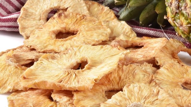 Zoom out shot on slices of dried pineapple
