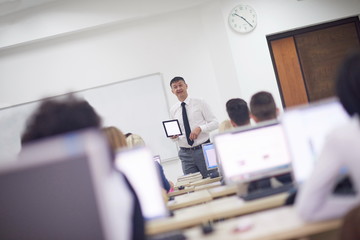 students with teacher  in computer lab classrom