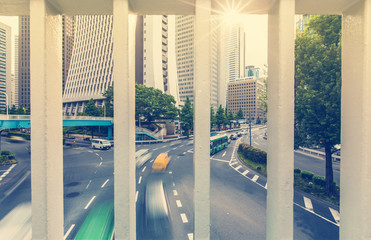 View of traffic and skyscrapers through the railing in Shinjuku, Tokyo