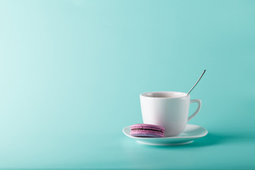 Coffee cup on aqua background with place for an inscription