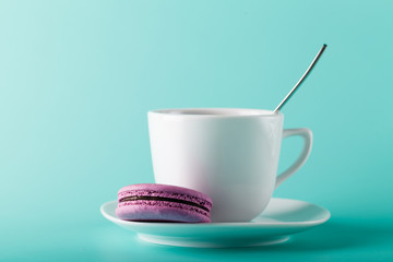 Coffee cup on aqua background with place for an inscription