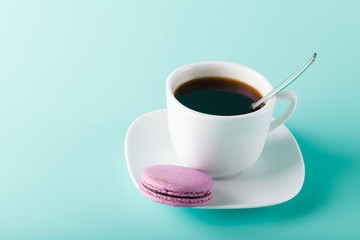 Coffee cup on aqua background with place for an inscription