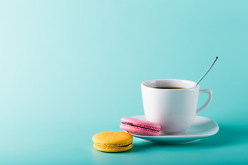 Coffee cup on aqua background with place for an inscription