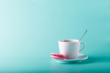 Coffee cup on aqua background with place for an inscription