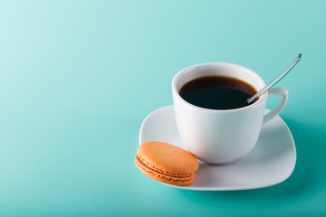 Coffee cup on aqua background with place for an inscription