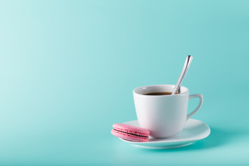 Coffee cup on aqua background with place for an inscription