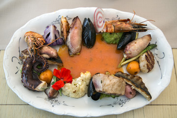 Seafood and fish on porcelain plate. © balakate