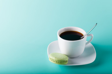 Coffee cup on aqua background with place for an inscription