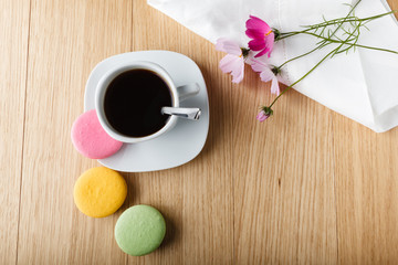 Colorful french macaron and cup