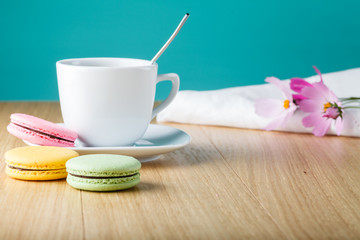 Coffe cup with colorful french macaron