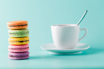 Five colorful french macaron and cup