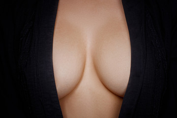 Topless woman body covering her big breast 