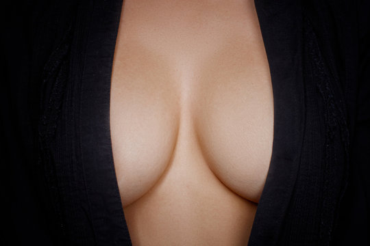 Topless woman body covering her big breast 