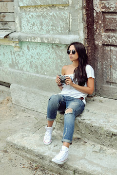 Fashionable girl with old camera