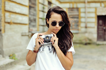 Trendy hipster girl with camera