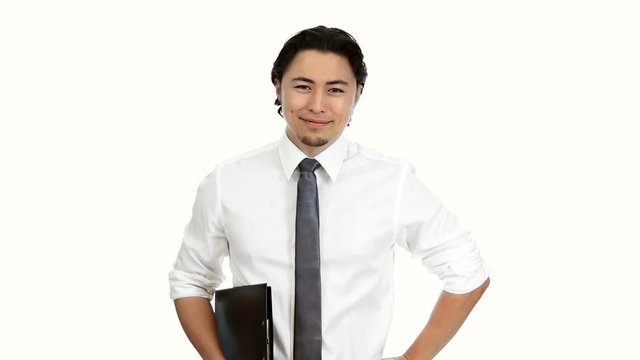 A handsome businessman in his 20s wearing a white shirt and grey tie, holding a laptop computer, working with a big smile on his face. White background.