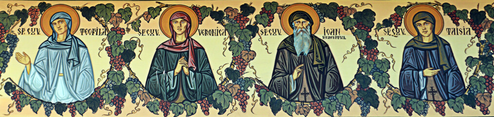 Saints painted on wall frieze outside Orthodox church, Bucharest