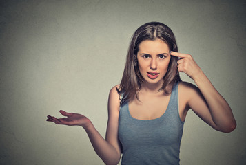 angry mad young woman gesturing asking are you crazy?