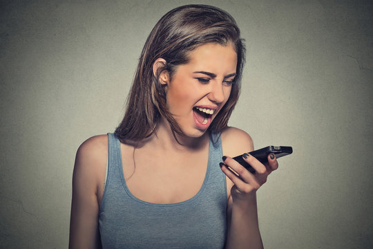 angry young woman screaming on mobile phone