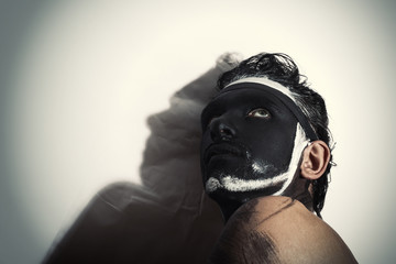 Portrait of man with black theatrical makeup