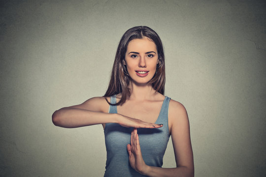 happy, smiling woman showing time out gesture with hands