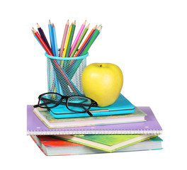 Back to school. An apple, colored pencils and glasses on pile 
