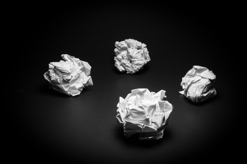 Crumpled paper on black background. Business frustrations, Job stress and Failed exam concept. Black and White filter.