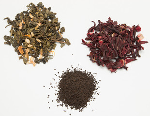 dry green red and black tea on a white background