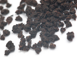 dry black tea on a white background