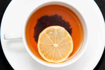 tea with lemon on a black background