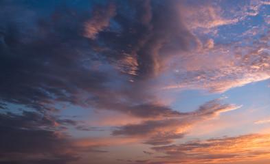 Dramatic sunset sky with orange colored clouds.
