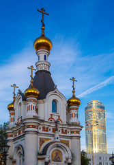 Fototapeta na wymiar Chapel and skyscraper Ekaterinburg day summer