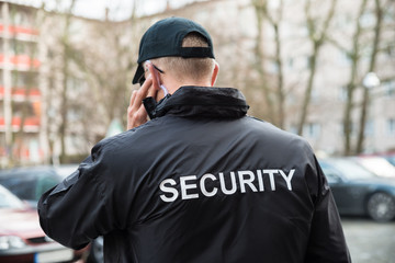 Security Guard Listening With Earpiece