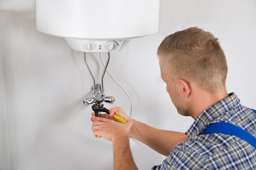 Repairman Repairing Electric Boiler