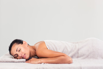Obraz premium Pretty woman resting on massage lounger
