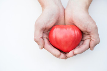 Tomato heart in the hands isolated
