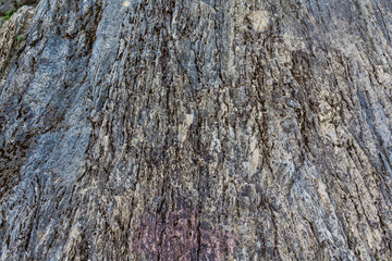 Gray rock destroyed by wind and rain over the years.