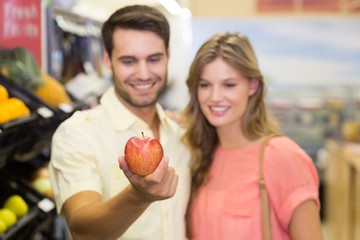 Fototapeta na wymiar Smiling bright couple buying food products