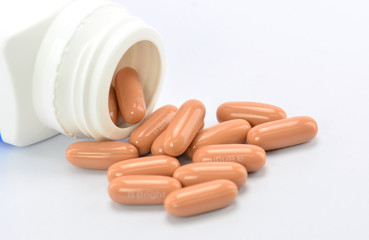 orange pills and pill bottle