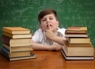 Schoolboy making with finger sign silence