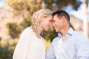 Fototapeta premium Smiling couple embracing and looking at each other intensively