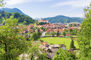 View of the Skofia Loka  town and castle covered with greenery and mountains.