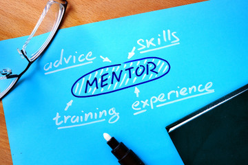 Blue paper with word mentor and glasses. 